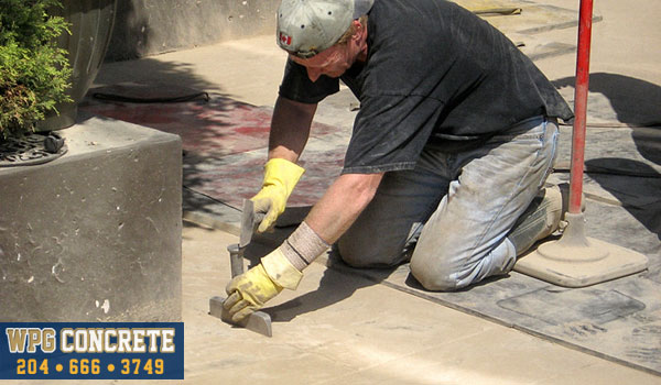 Adding detail to stamped concrete in Winnipeg, Manitoba